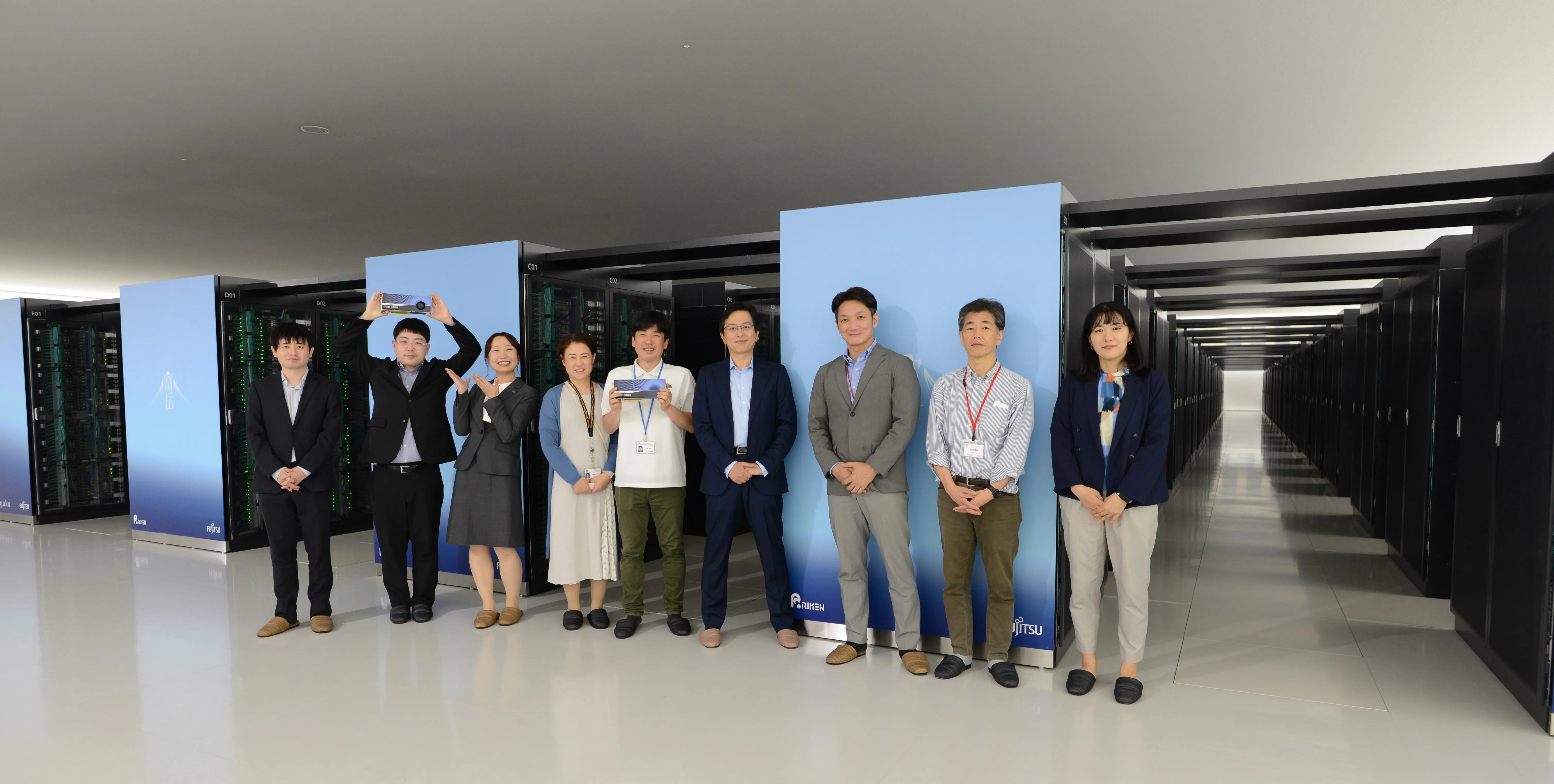 スーパコンピュータ富岳前での集合写真（左からアイベックステクノロジー 望月・加藤・榎本、理化学研究所様、HPCシステムズ様）
